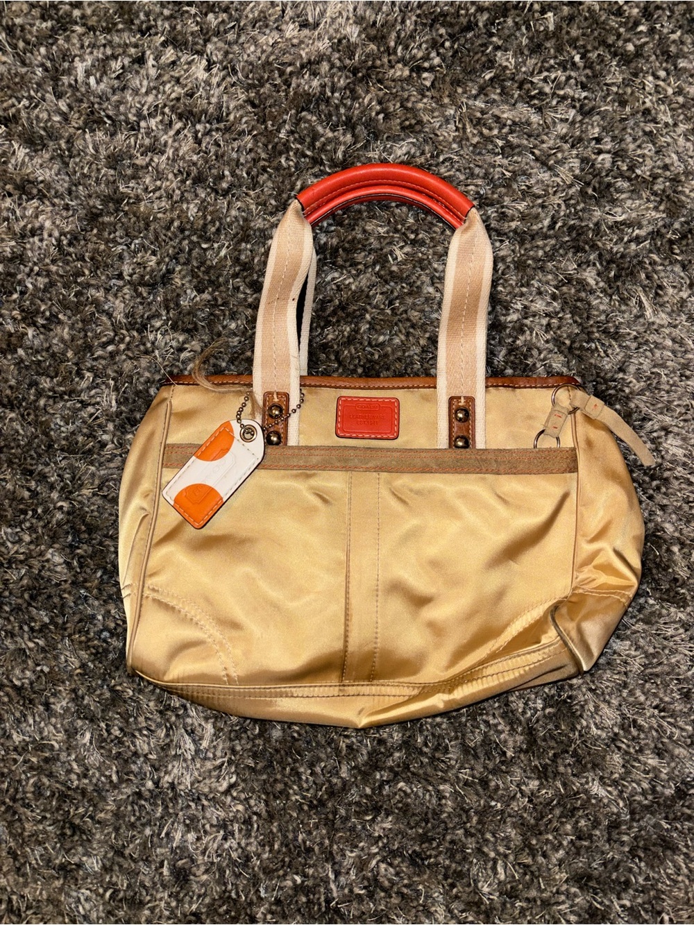 Coach Gold Shoulder Tote with orange Accent Handles